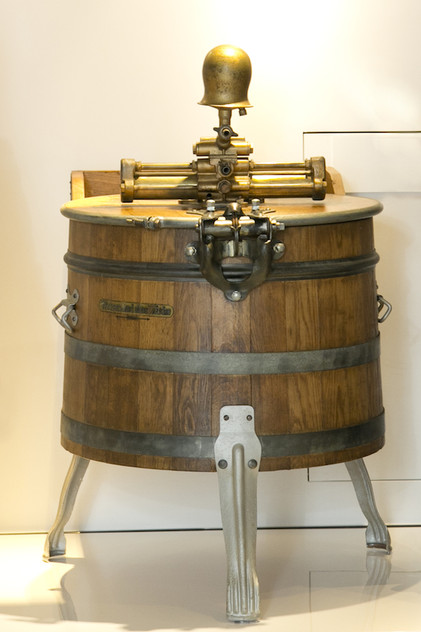 An oak washing machine by Miele, the first water-powered one