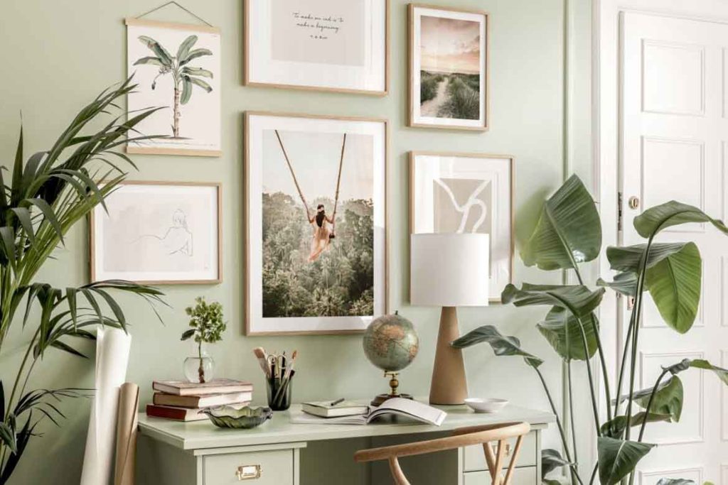 sage green maximalist study space desk paintings and plants for productivity