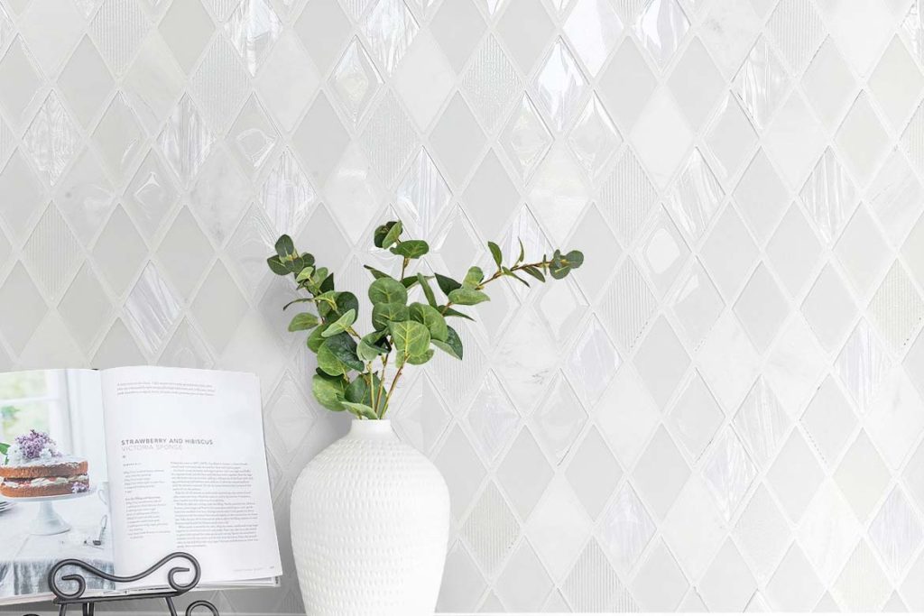 white crystal kitchen backsplash with jasmine plant and cook book