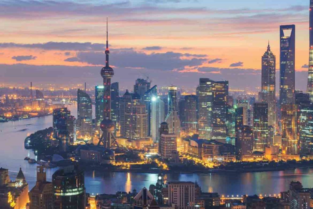 shanghai china large city at night with lights and river