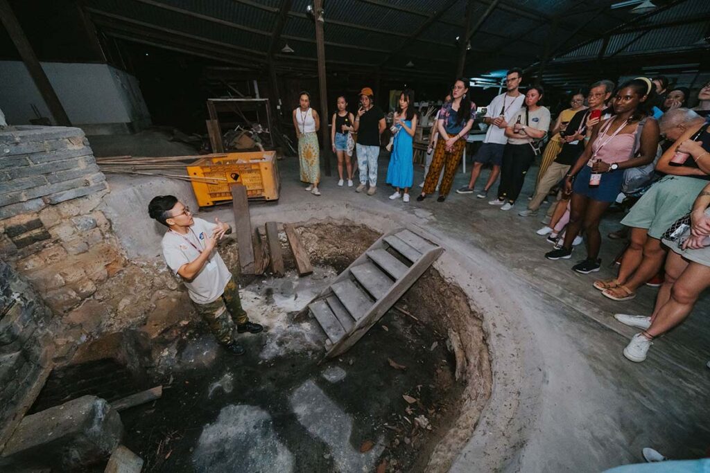 Michelle Lim of Mud Rock Ceramics leading a tour of Dragon Kiln she saved