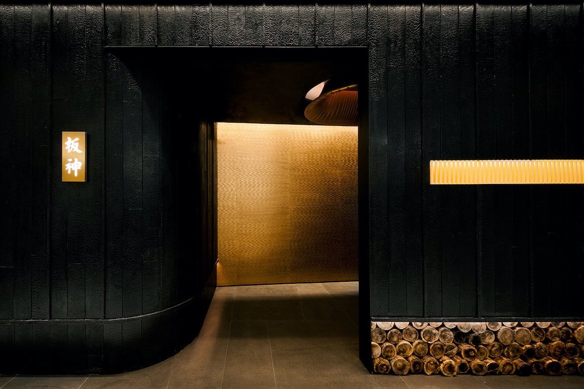 The front of God of Teppanyaki is panelled with blackened wood and accentuated by hints of gold.