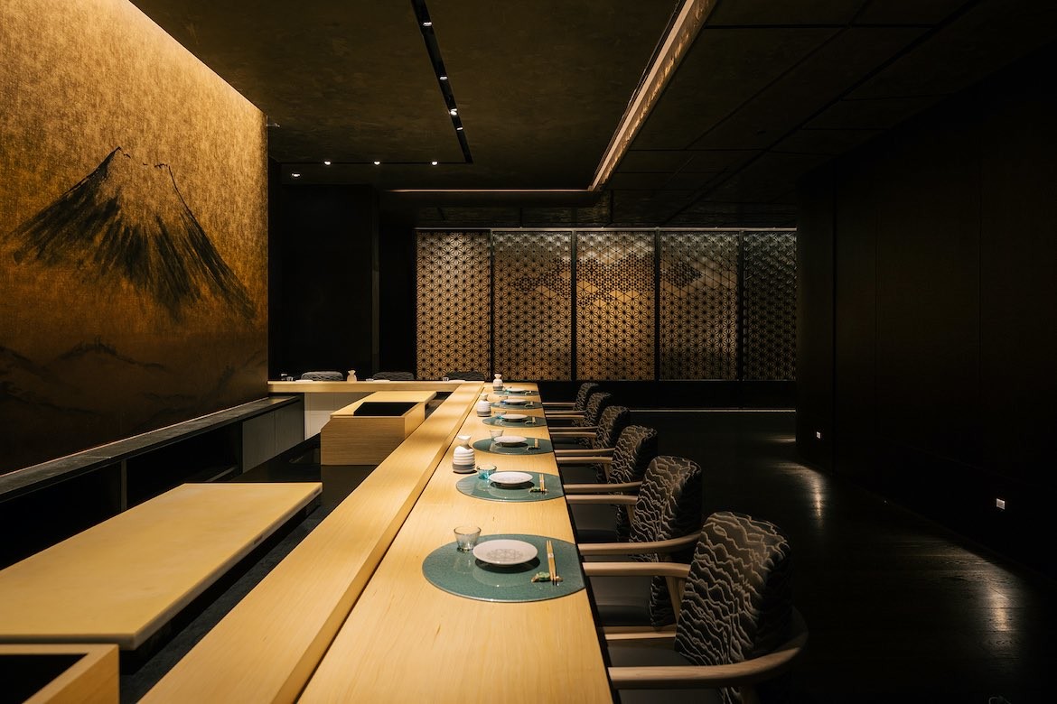 Rows of seats line a table in the Sake bar in God of Teppanyaki.