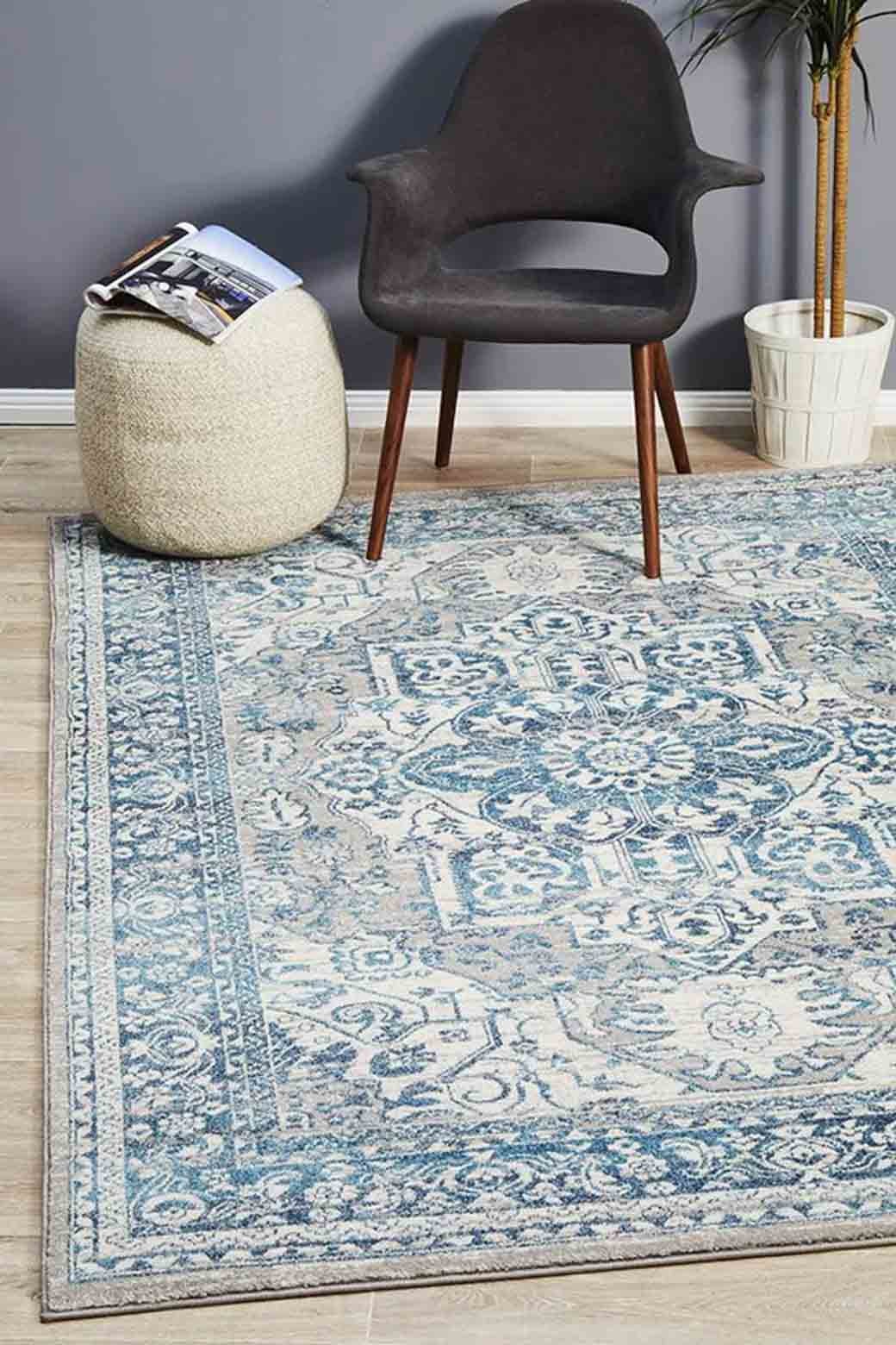 blue and brown subtle persian rug in living room with chair and plant soft fake washable cheap
