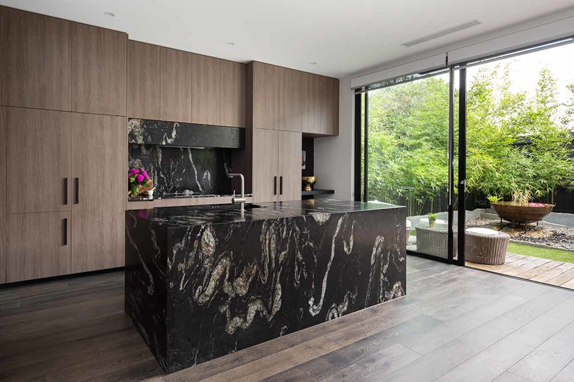 black marble countertop with white vein moody kitchen with timber accents