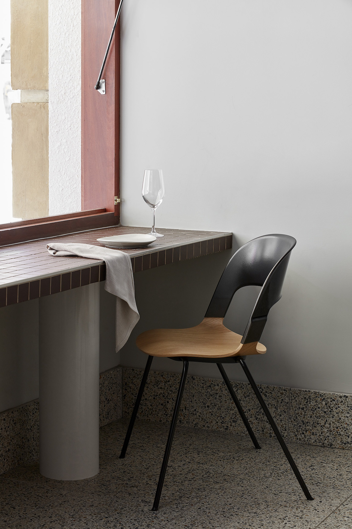 A chair and maroon bar in Stables Bar by State of Kin.