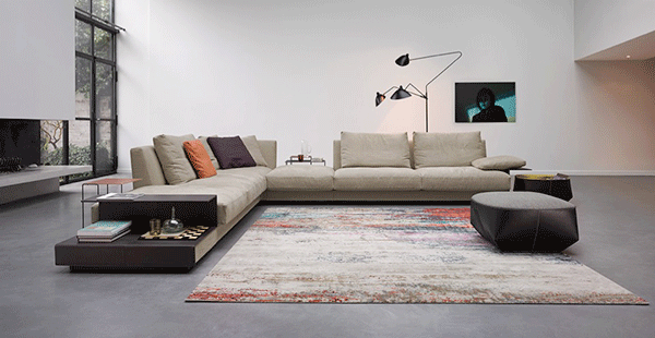 Grand Suite, designed by EOOS. The true luxury of living. Grand Suite makes a statement about what is preciously private. Designed with the true values of the culture of living. Precise lines, honest craftsmanship, fine materials. Personal and prestigious – with the aesthetics of something special. Clear contours, soft shapes – a genuine showcase of sofa couture de luxe. The spacious, soft cushions ensure that special comfort. The horizontal line of the upholstery flows into armrest and board. Best saddle leather, elaborately finished seams – the perfect union of sense and sensibility. A place close to hand – for a good glass of Baron Rothschild or your favourite book. Grand Suite likes demonstrating its grandeur in free space – classic, cultivated, supremely confident. A genuine sofa landscape. Sublime and elegant. Pure elegance for what really is precious – your private life.