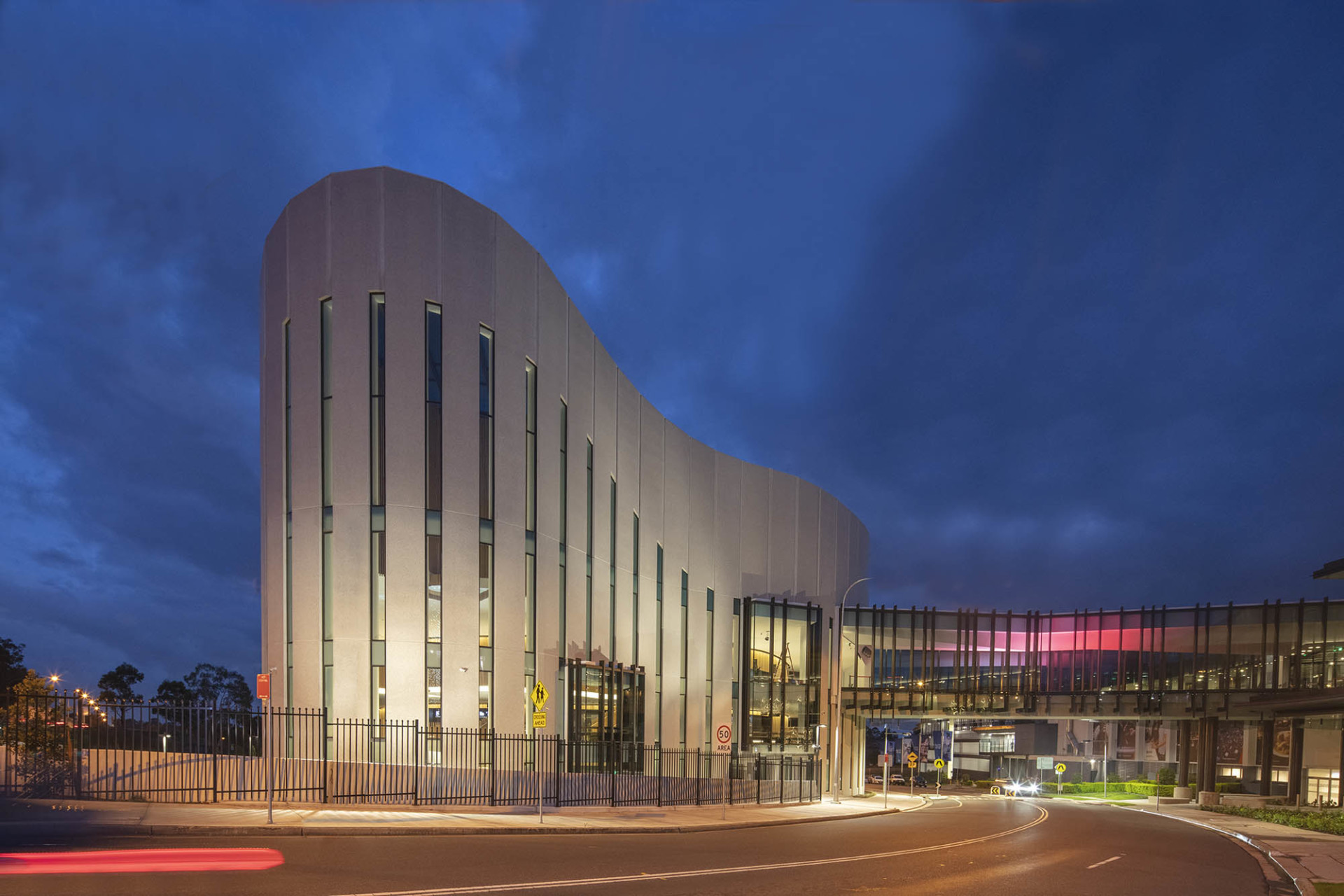 The curving and colossal cement exterior of Sydney Coliseum Theatre.