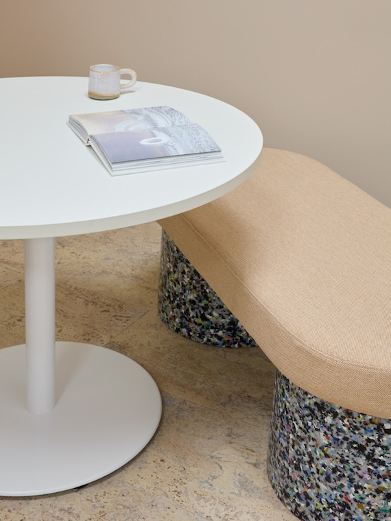 A sculptural bench seat with black and white terrazzo legs in New Me medical centre by Rezen Studio.