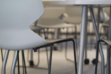 A close up of Buro's white ergonomic Konfurb Fly Sled Chairs.