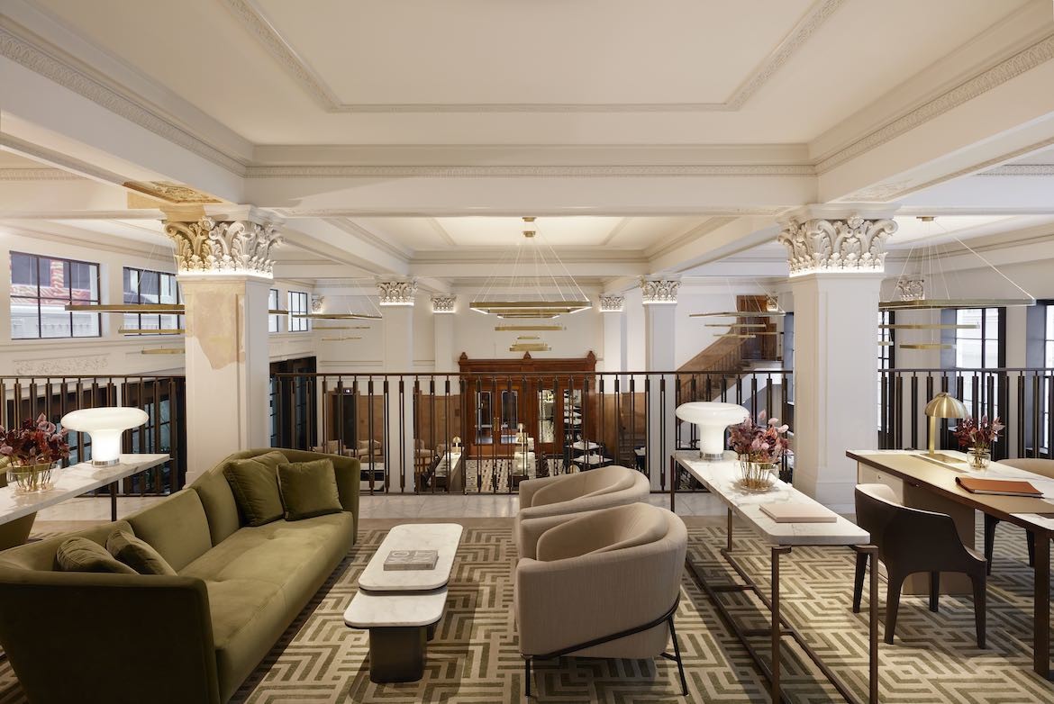 Plush lounges and carpeting in the communal space of the Hilton Melbourne Little Queen Street.