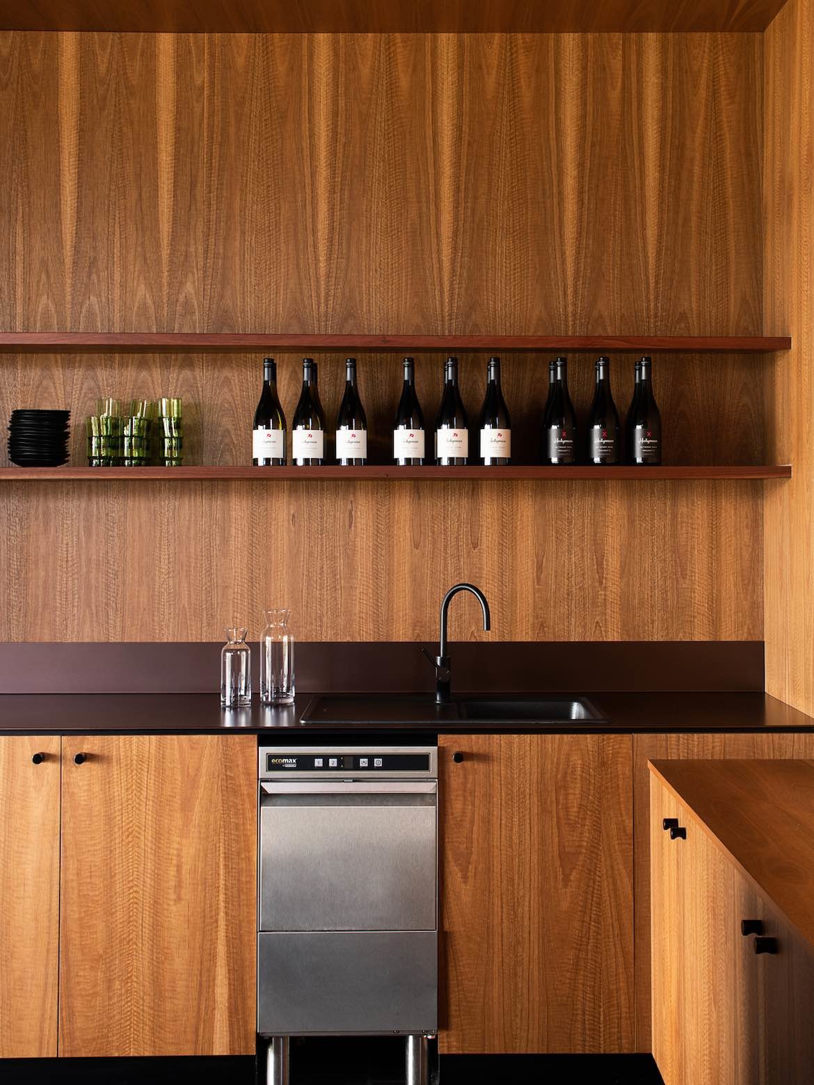 Warm timber cabinetry, a sink and dishwasher in Stoney Rise Cellar Door.