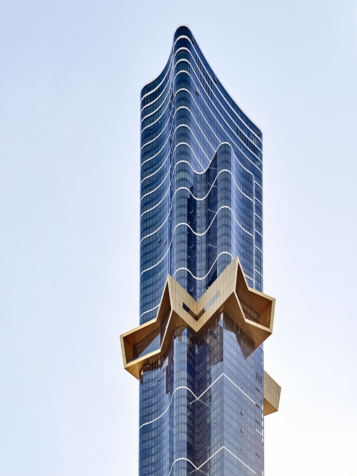 The curving exterior with gold starburst detail of 108 Australia, designed by Nonda Katsalidis and Fender Katsalidis.