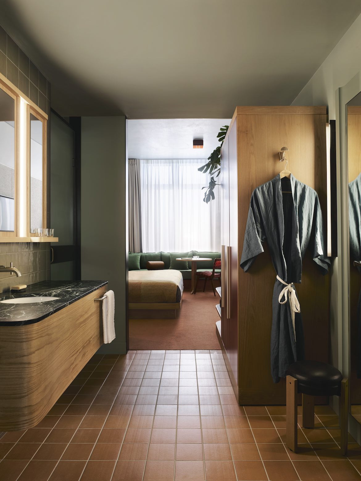 Ochre and eucalyptus tiles in a bathroom by David Flack in Ace Hotel