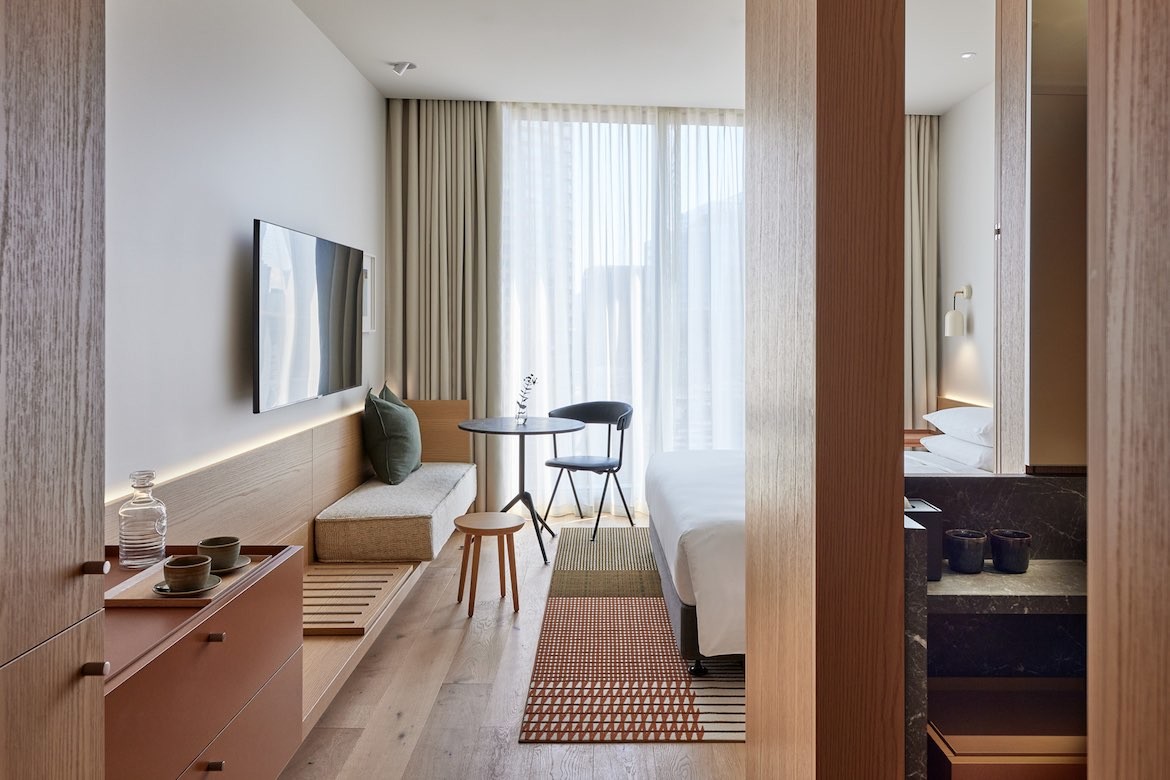 The beige, sage and brown interior of a Standard King Room in the Hyatt Centric.