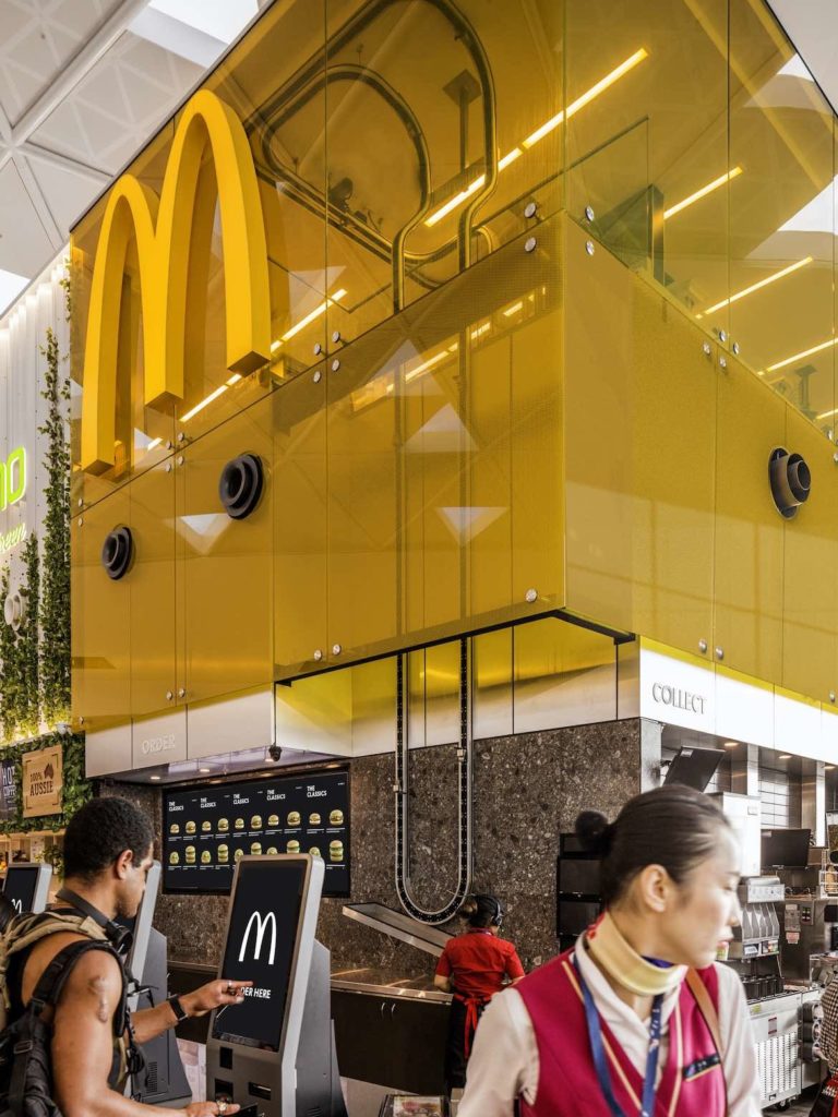 A transparent yellow screen highlights the McDonald's ordering area in Landini Associates' McDonald's Sky Kitchen.