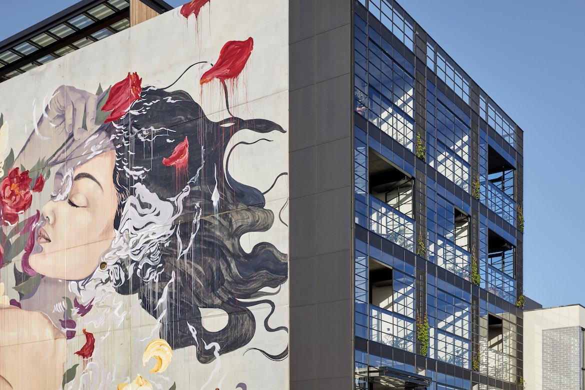 A painted woman on the side facade of Nightingale 1 by Breathe