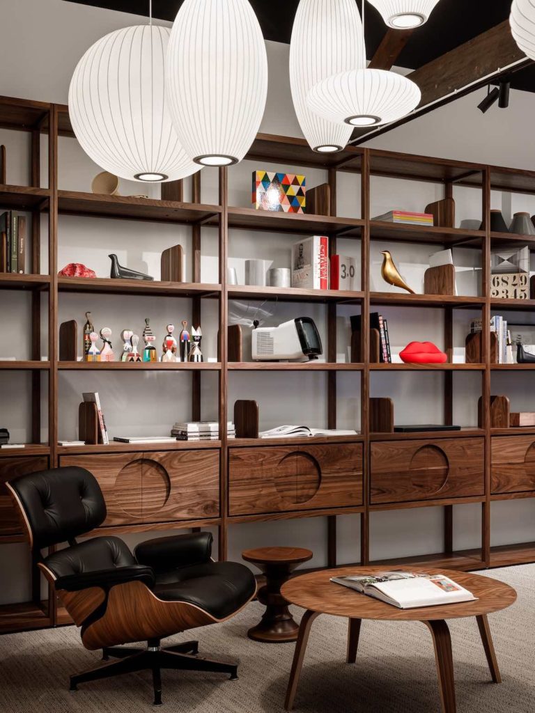 An Eames chair in front of the Elan Plus Grid Shelving designed by Boris Tošić.