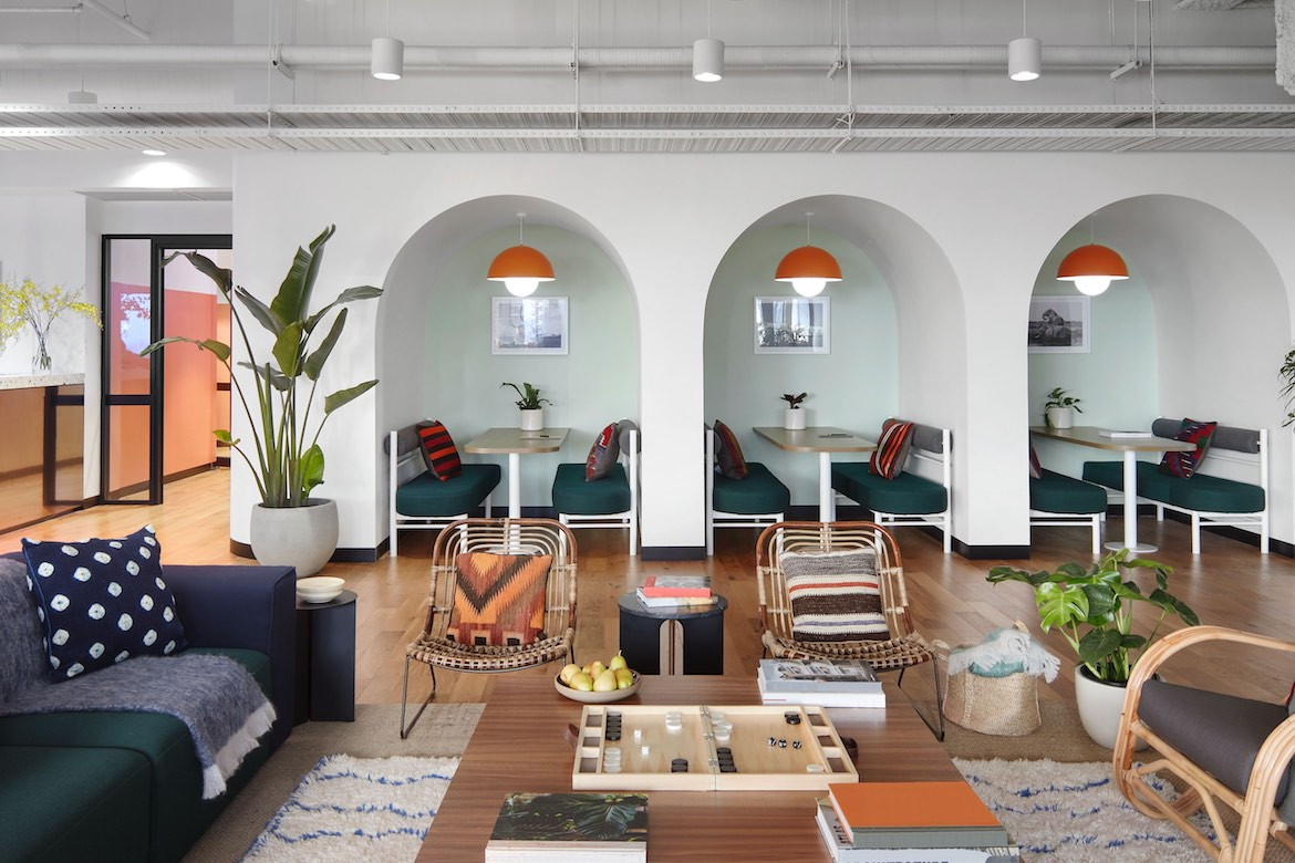 Flexible workplace solutions in the WeWork office, including arched nooks and lounges.